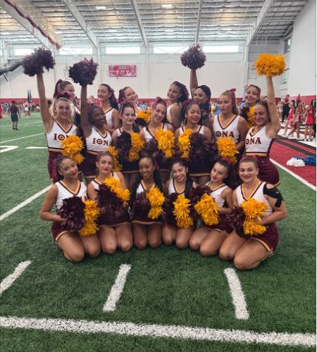 Iona Cheerleading Team group photo posing and smiling on a field.
