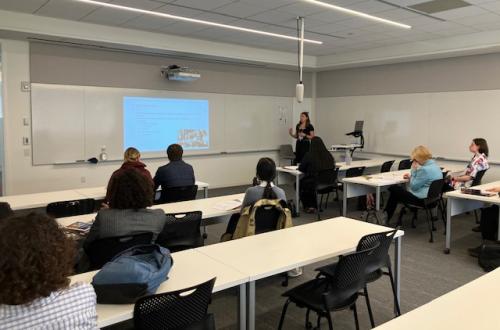 Kaitlyn Incandela presenting at the AI conference.