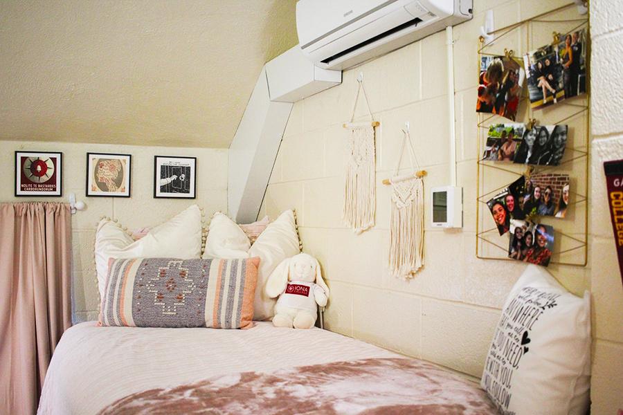 A bed with a decorated pillow in Rice Hall.