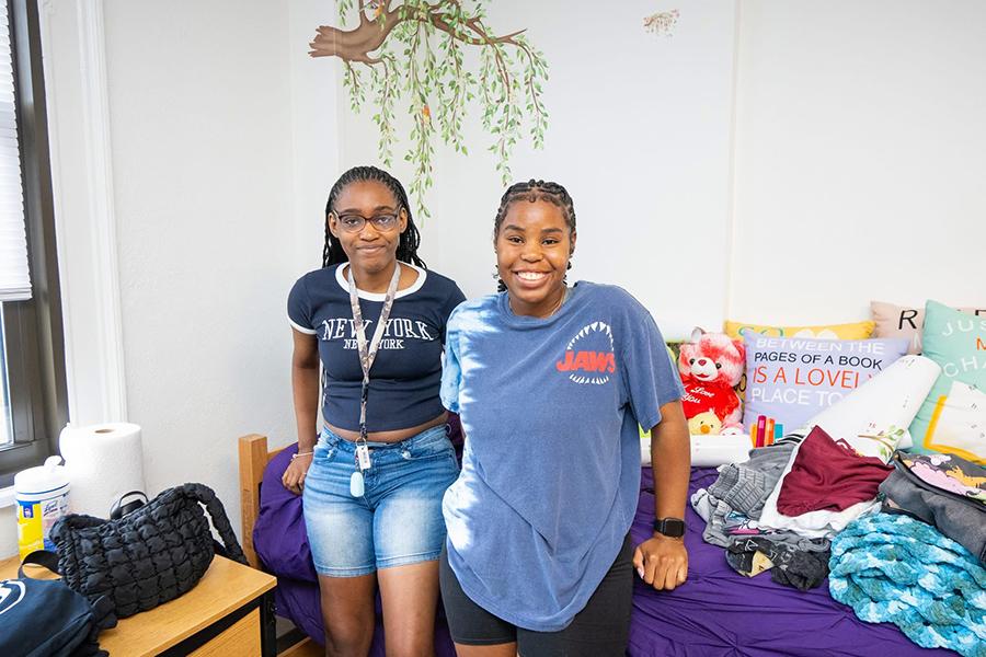 Two female roommates smile in their room in Bohm.