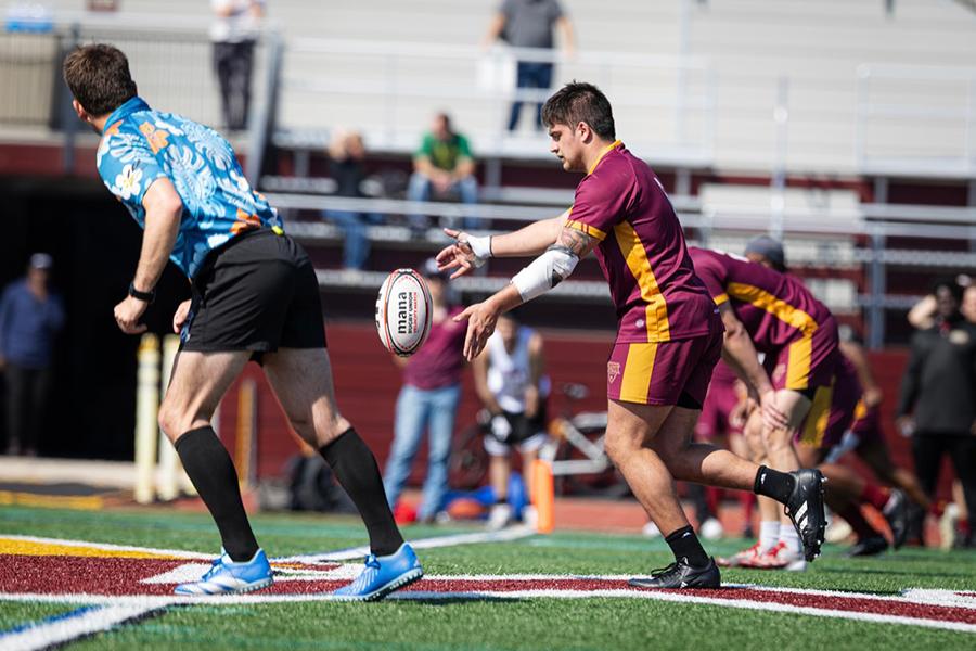 The Rugby Team kicks the ball down field. 