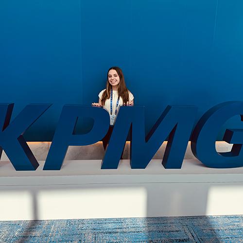 Samantha Iaccarino in front of the KPMG sign.