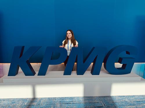 Samantha Iaccarino in front of the KPMG sign.