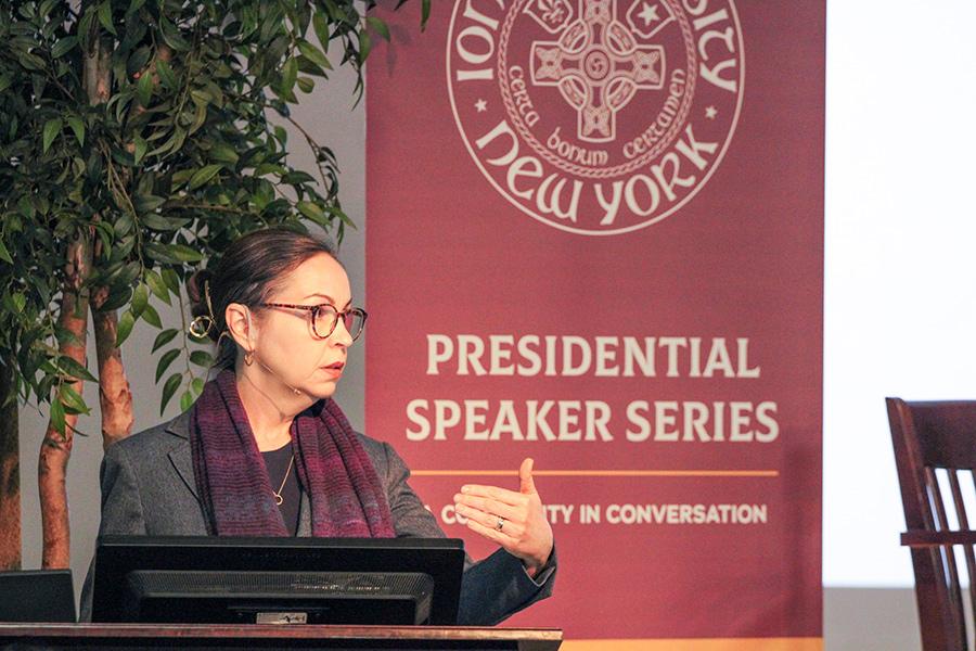 Dr. Vallor speaking at the podium in Romita Auditorium for the Presidential Speaker Series.