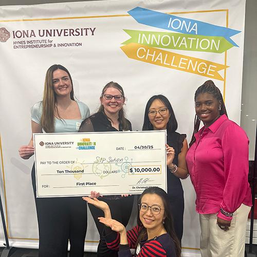 The SipSation pose with the check from winning first place.