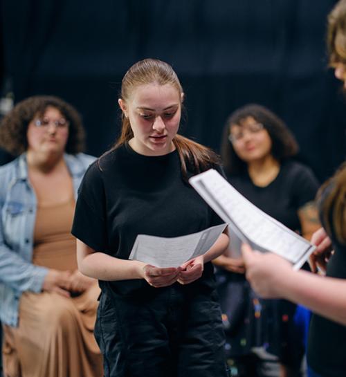Stage management students talk through notes.