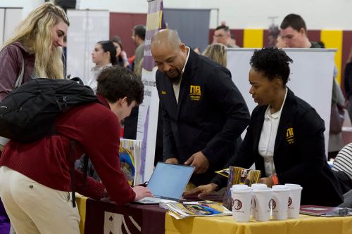 Students fill out applications at the career fair.