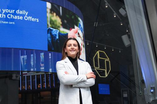 A student in front of a Chase billboard in New York City.