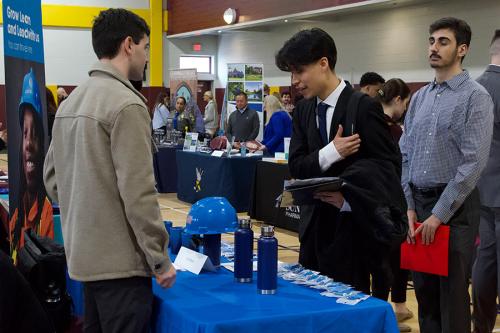Students talk with the Con Ed recruiter at the career fair.