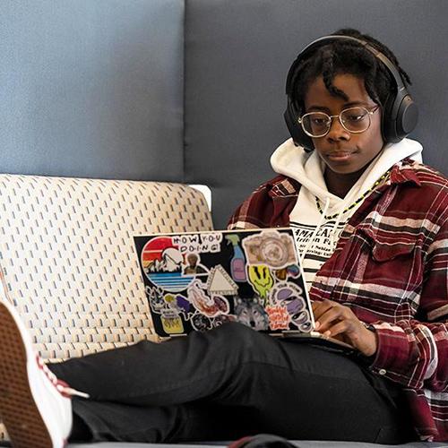 A student working on their laptop in LSB.