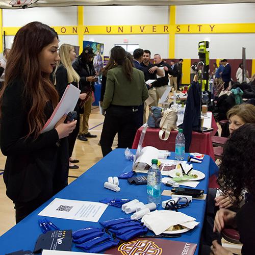 A student speaks with a company at the career fair.