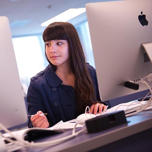 A student works at a compueter in a lab.