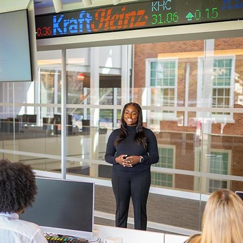 A student presents in the trading room in LSB.