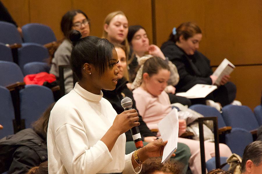A student asks a question in a seminar.