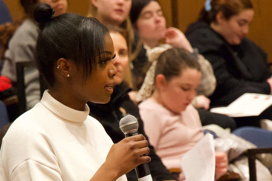 A student asks a question in a seminar.