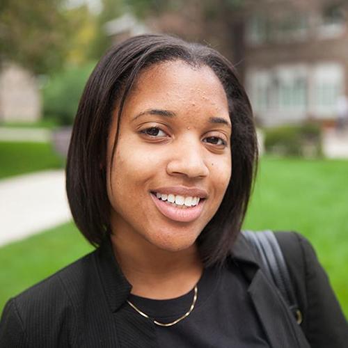 A special education student smiles on the quad.
