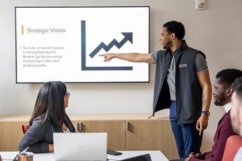 Students work on an analytics presentation in the LSB.