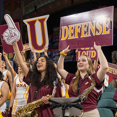 Students in the pep band support the team.