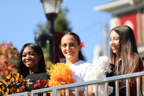 Cheerleaders smile during Homecoming.