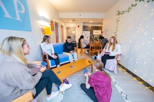 Students relax together in a communcal dorm space.