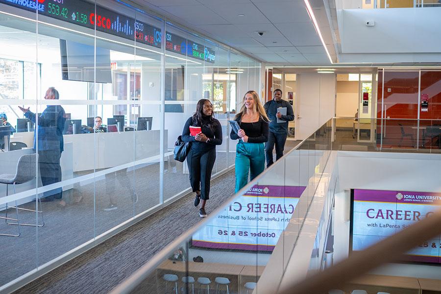 Two students walking in hallway of LaPenta School of Business