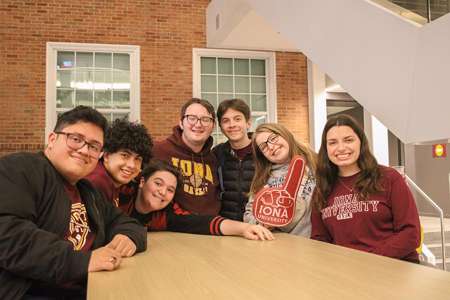 Students smile in the atrium of the LSB.