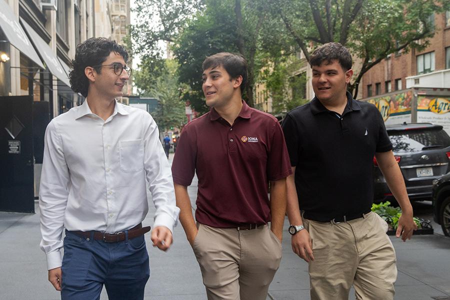 Three business students walk in NYC.