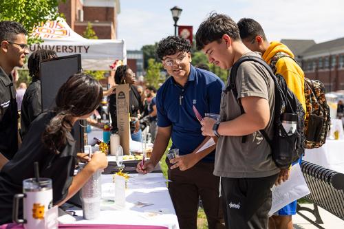Students sign up for a club at the Involvement Fair.