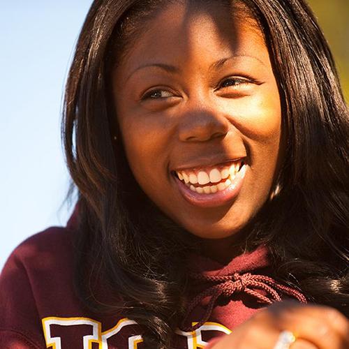 An education student in an Iona sweater smiles.