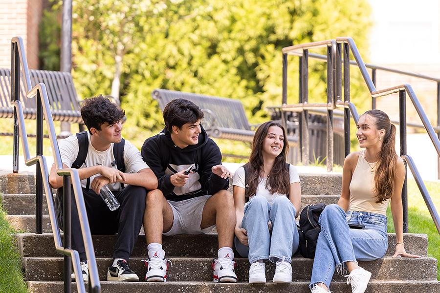 Students chat on the steps near the Murphy Green.