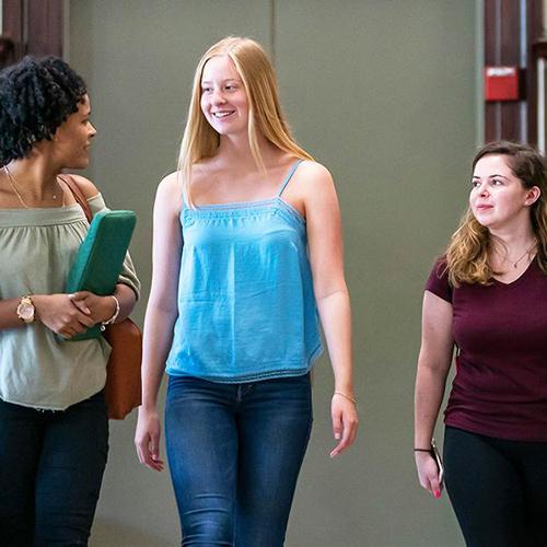 Students walking in the library.
