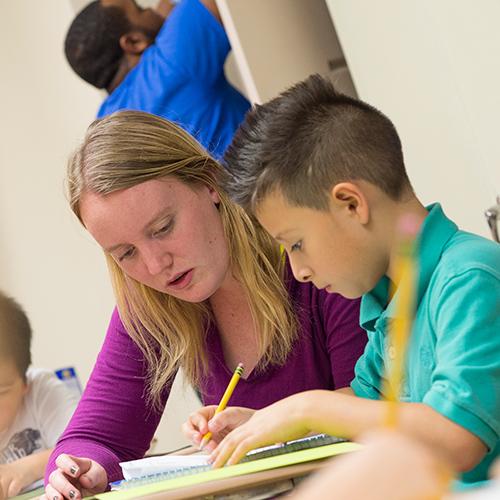 A teacher and student work together in the classroom.