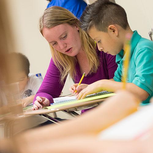 Teacher one-on-one with adolescent student