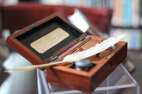 An antique quill and ink holder.