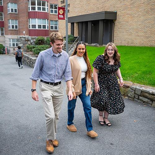 Three students walking by the Murphy Center.