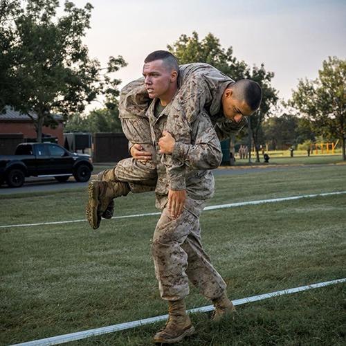 Tommy Byrnes carrying a person over his shoulder for marine training.