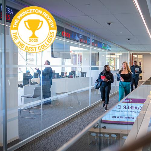 Students walk past the Trading Floor with the Princeton Review logo.