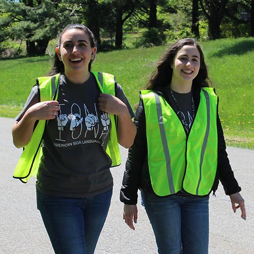 Two students from the ASL club at the HLAA walk for hearing.