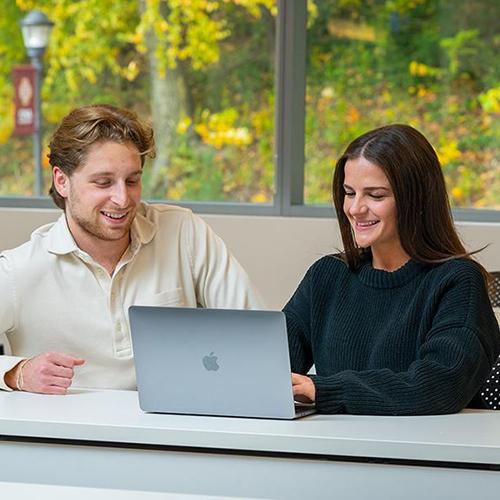 Two students work together in a business class.