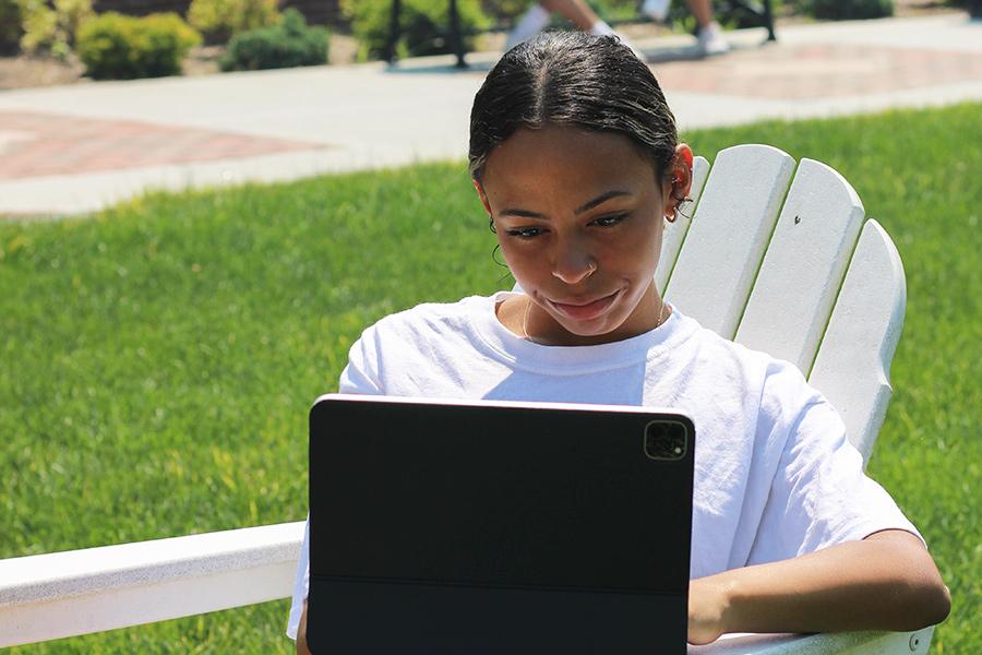 A student takes a virtual tour on a laptop.