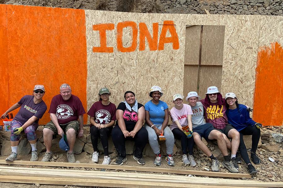 Volunteers in Peru help to build a house.