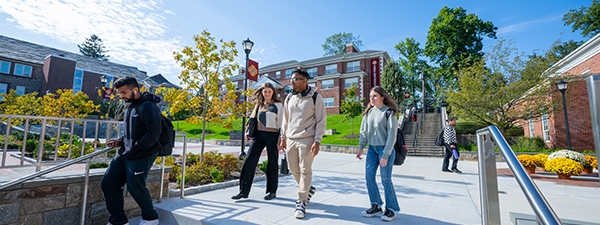 Students walk on campus on a spring day.