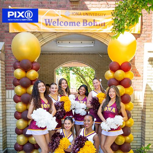 The cheer team with the Welcome Bohm sign and PIX 11 logo.