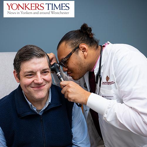 Yonkers Times logo with Iona nursing student examining a patients ear.